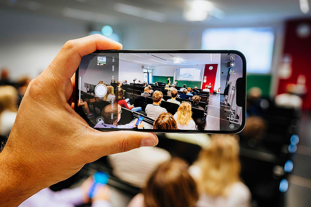 Ein Handy filmt eine Lehrsituation.